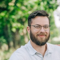 DJ Marrell headshot man wearing glasses