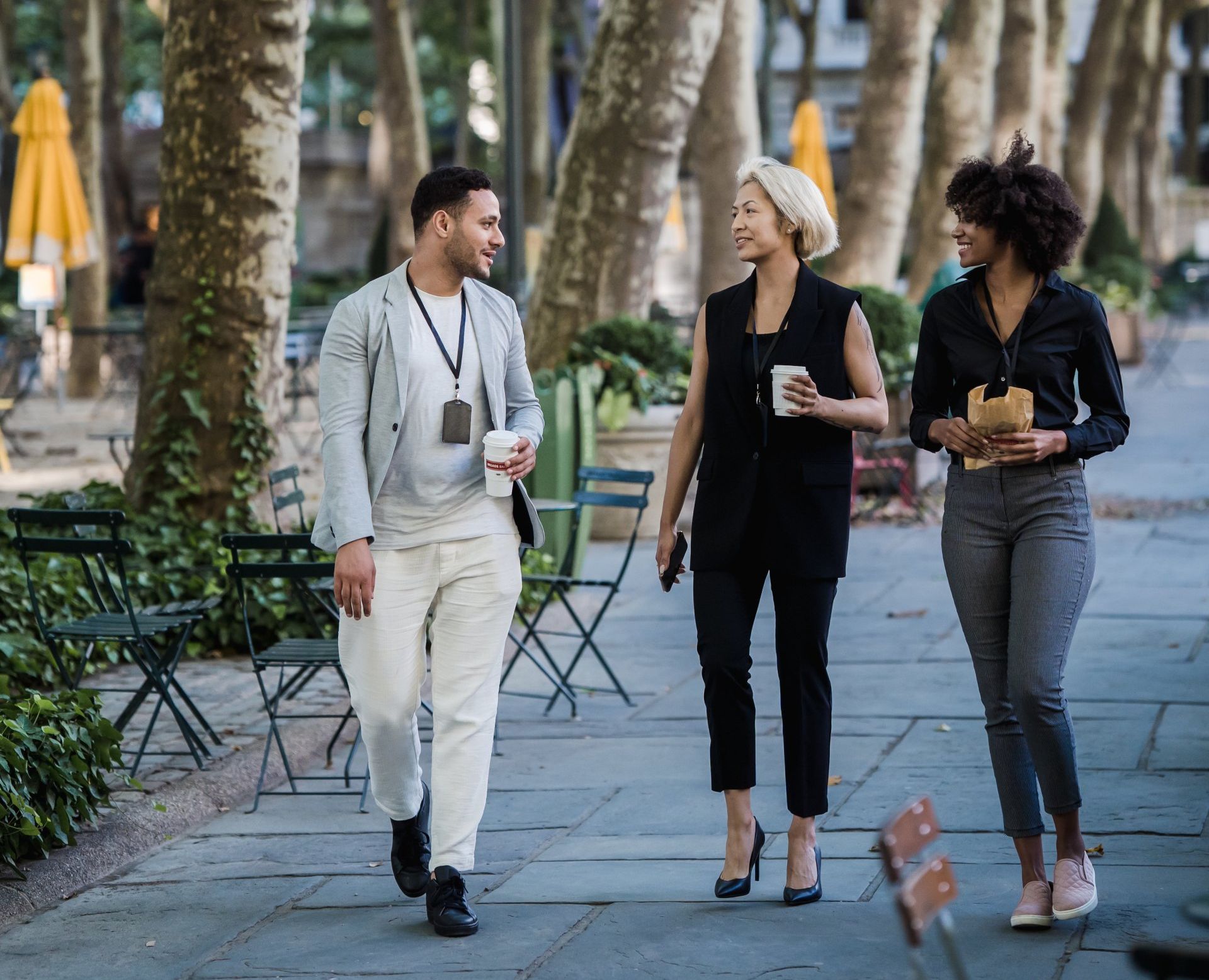 three people walking in business casual outfits