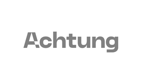 Das Wort „Achtung“ steht auf weißem Hintergrund.