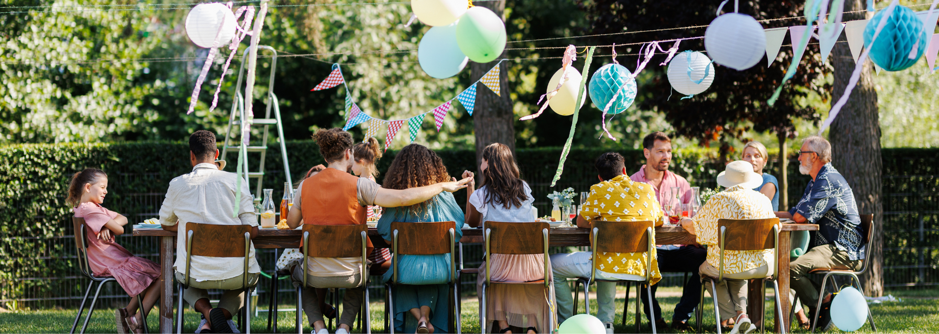 Picture of a seated event with colourful decorations or an outdoor party in the sunshine. Picture of a seated event with colourful decorations or an outdoor party in the sunshine.