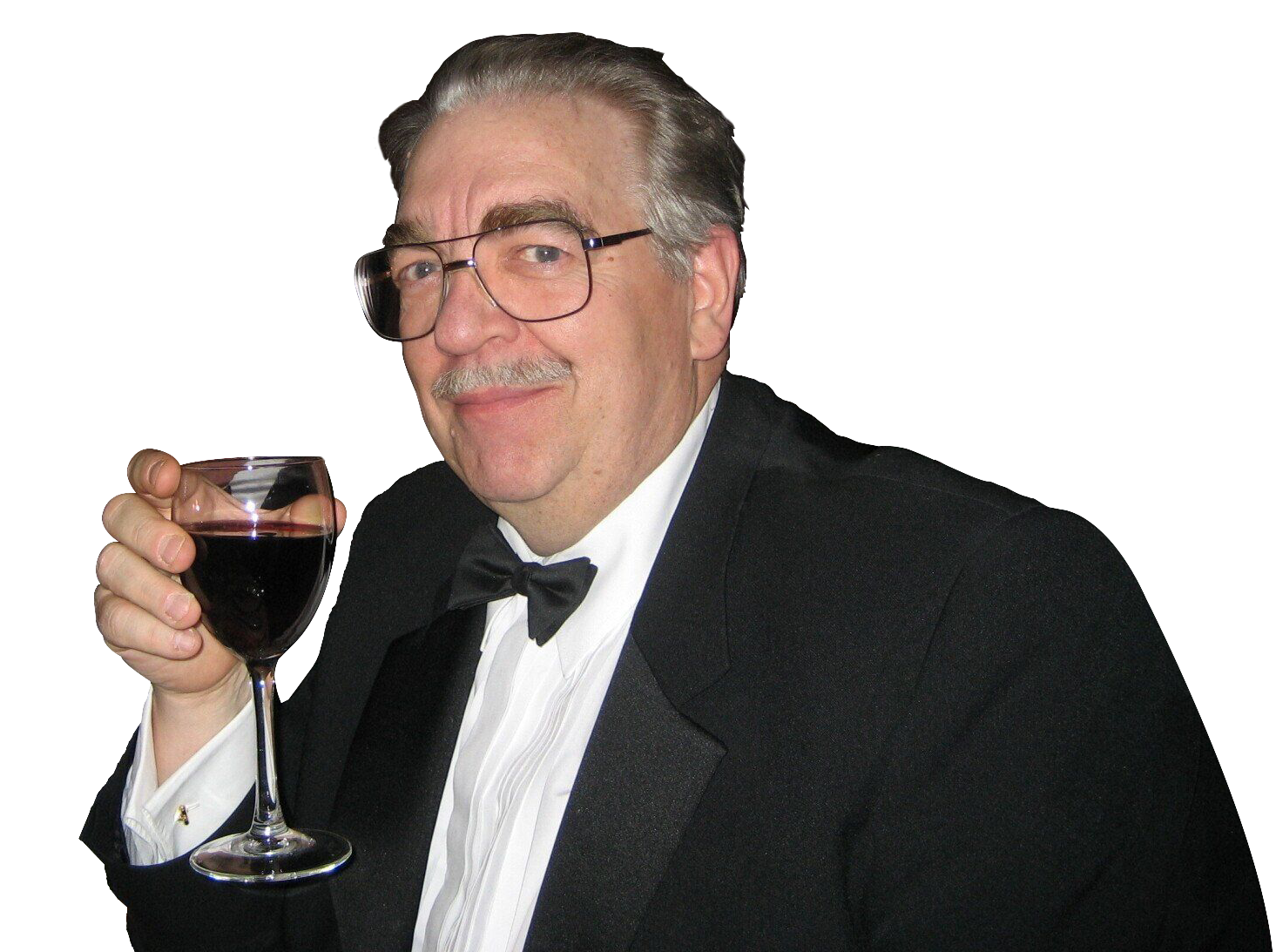 A man in a tuxedo is holding a glass of wine