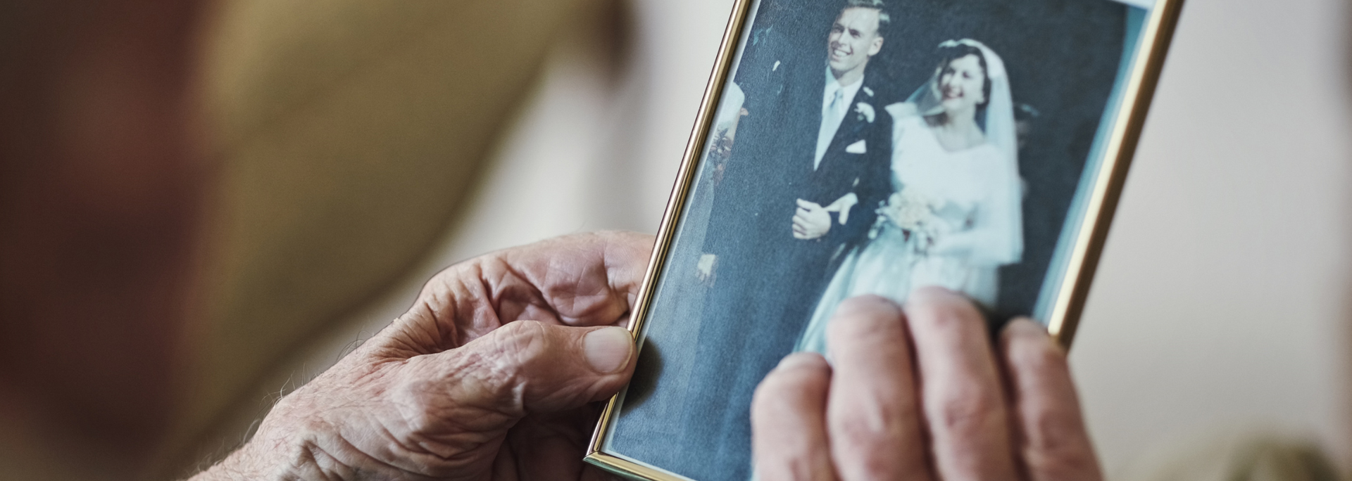 Picture of someone looking plaintively at a picture of a spouse. Picture of someone looking plaintively at a picture of a spouse.