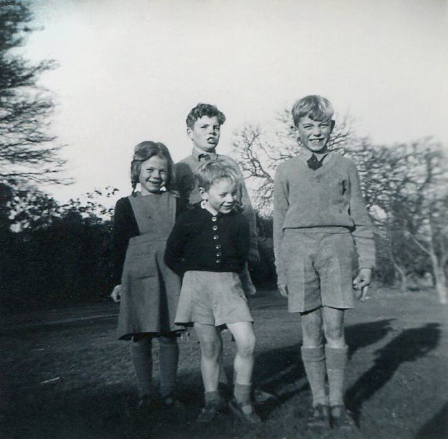 A black and white photo of a group of children