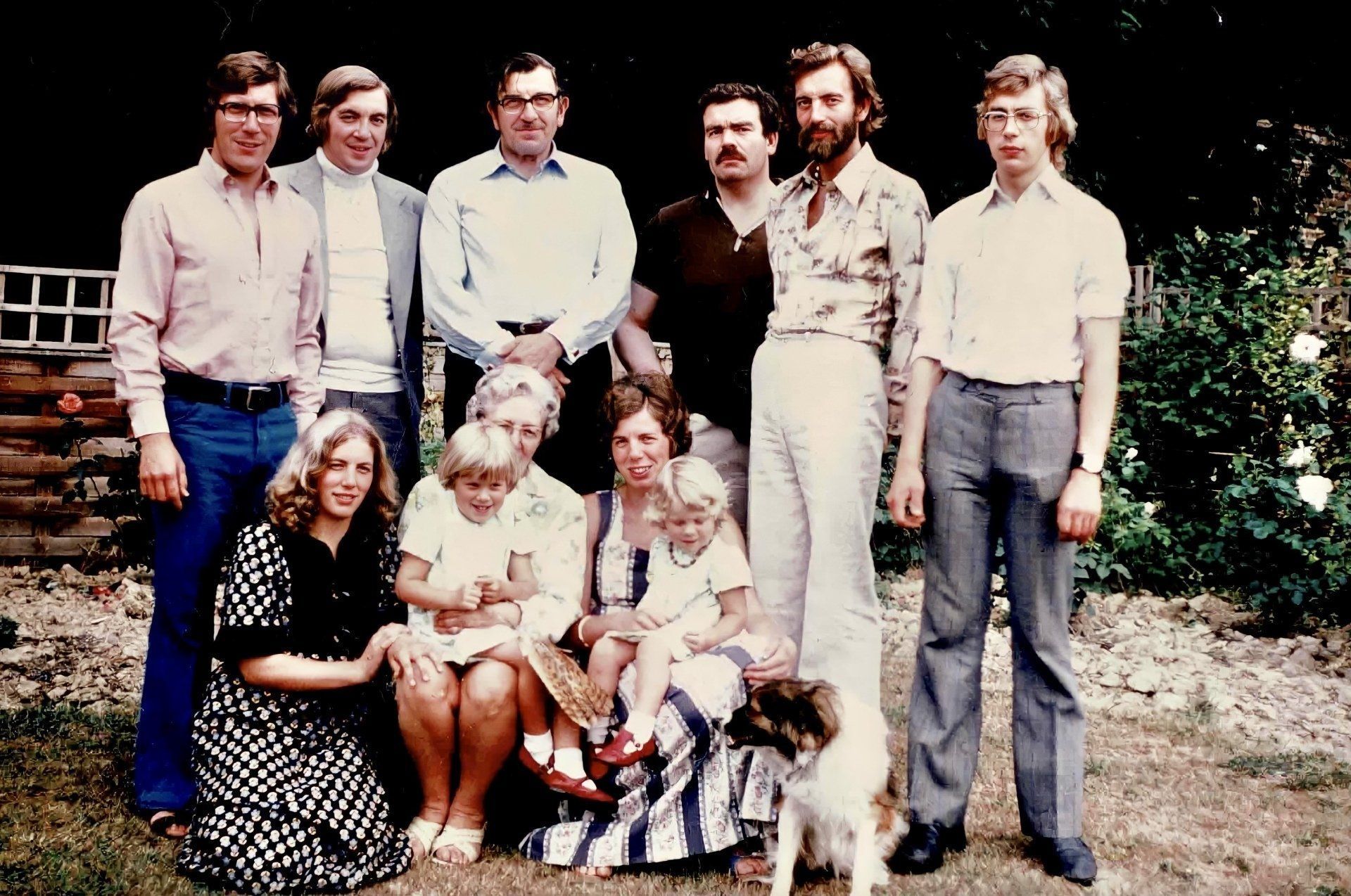 A group of people posing for a picture with a dog
