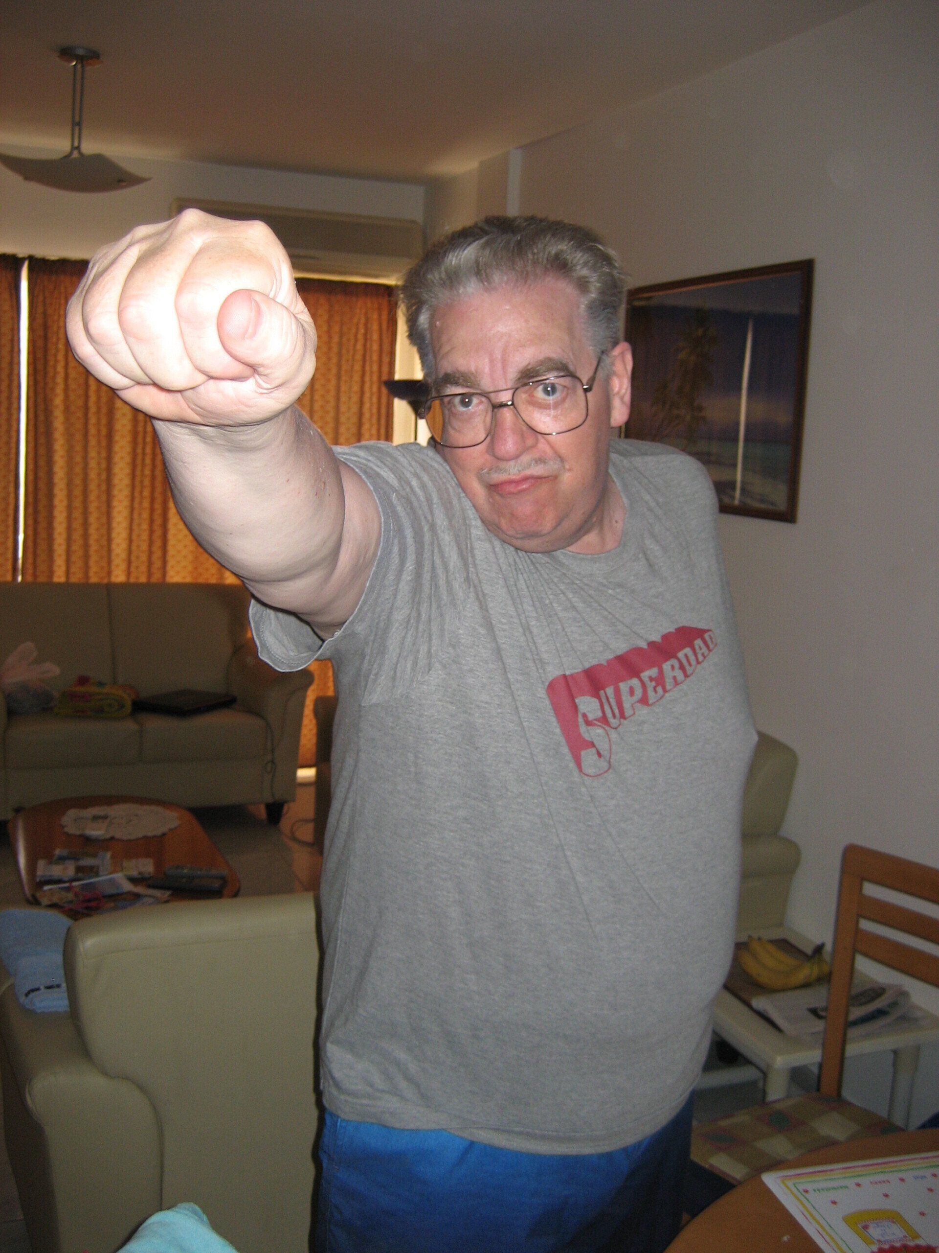 A man wearing a grey shirt with the word captain on it