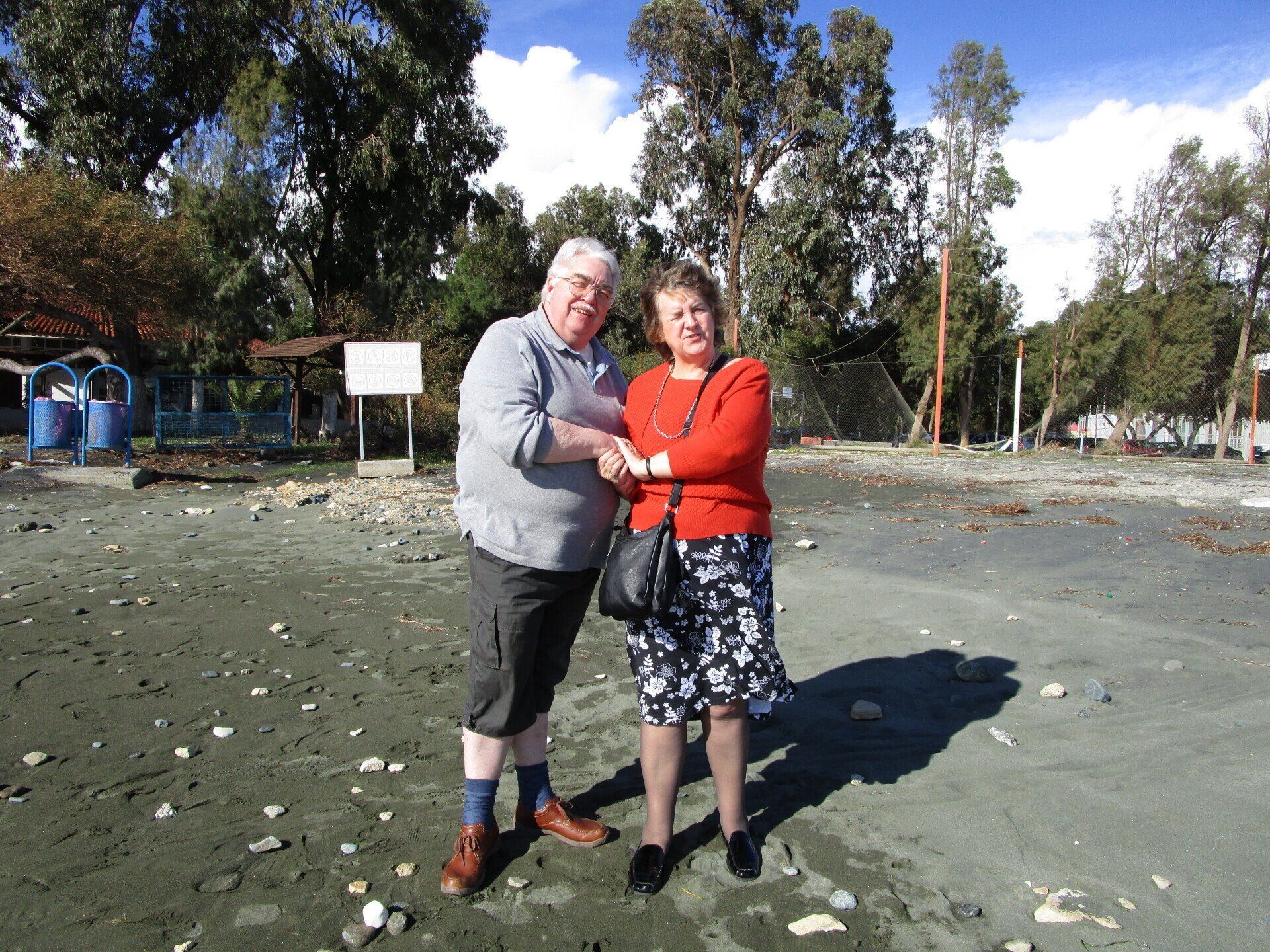 A man and a woman are shaking hands in a field