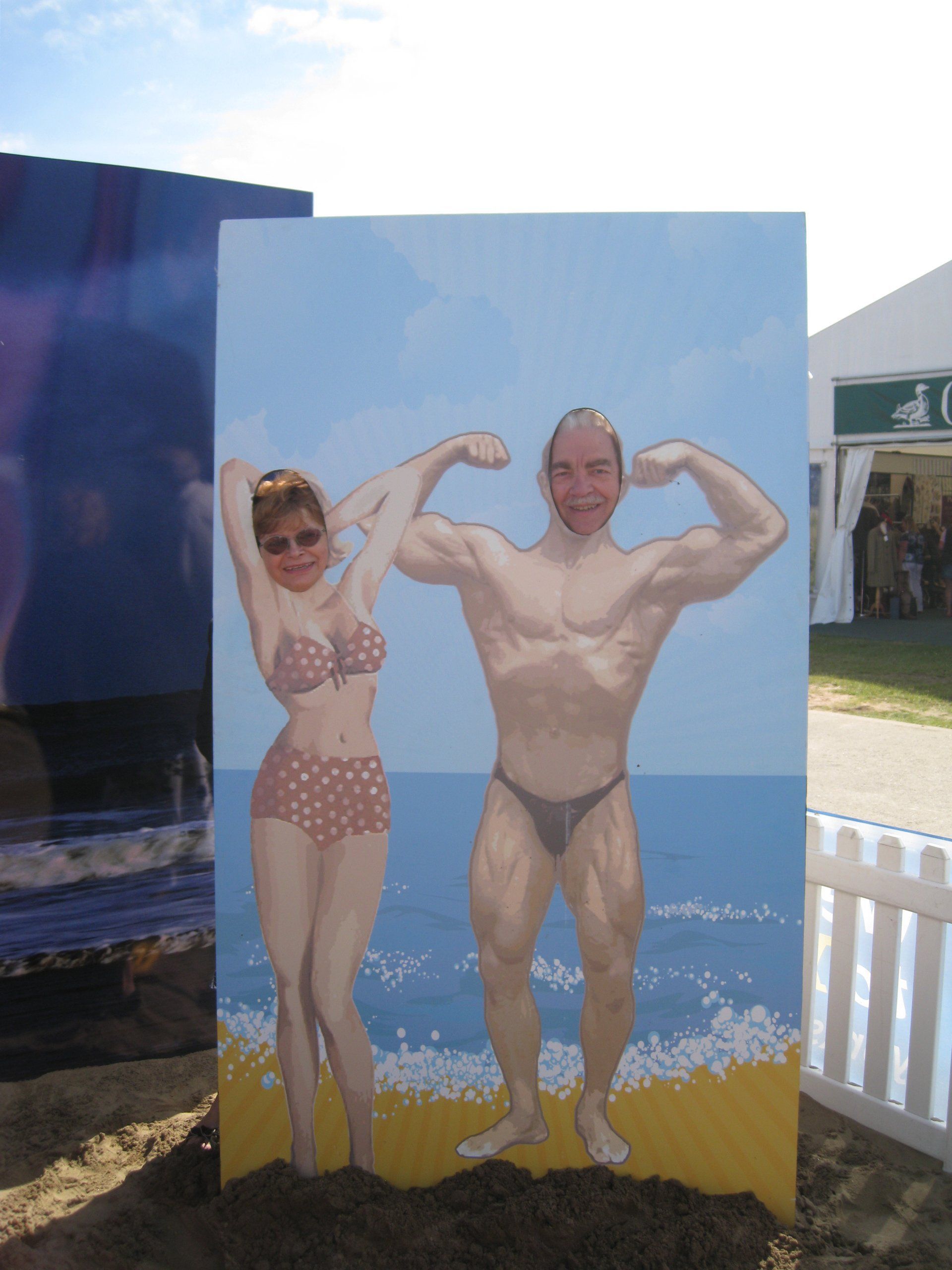 A cardboard cutout of a man and a woman on the beach