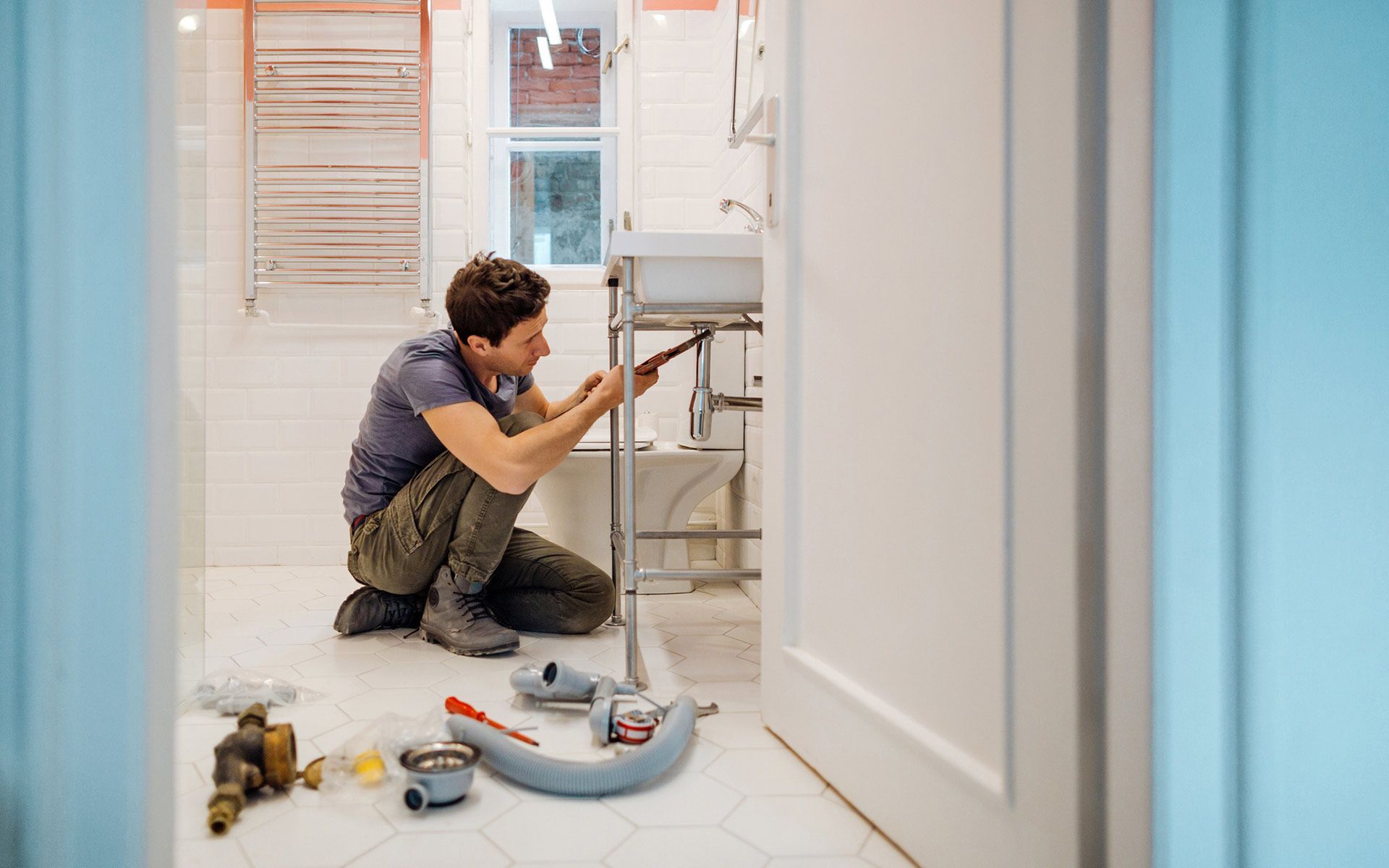 Man Fixing Bathroom Sink — Navarre, FL — Navarre Plumbing & Gas