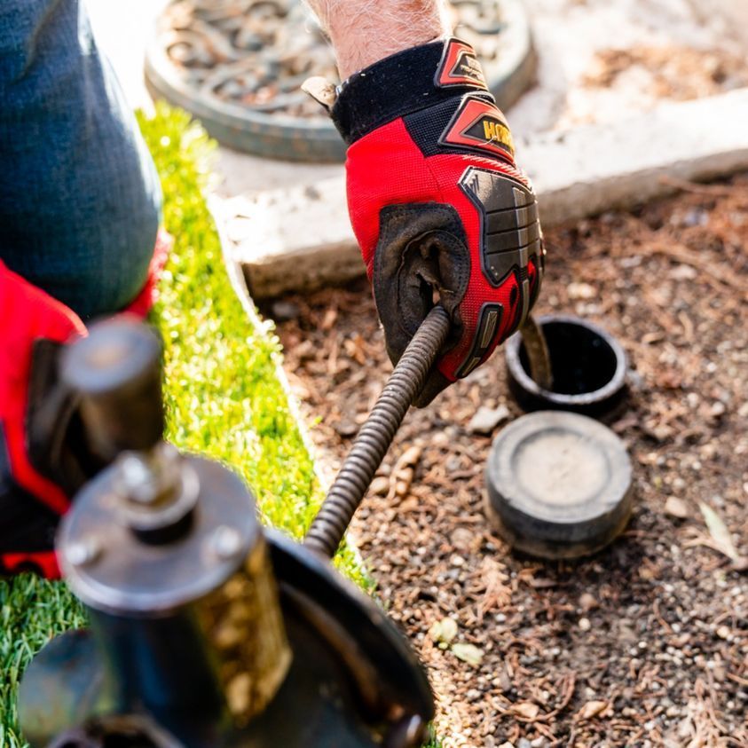 Man Repairing Heater — Navarre, FL — Navarre Plumbing & Gas