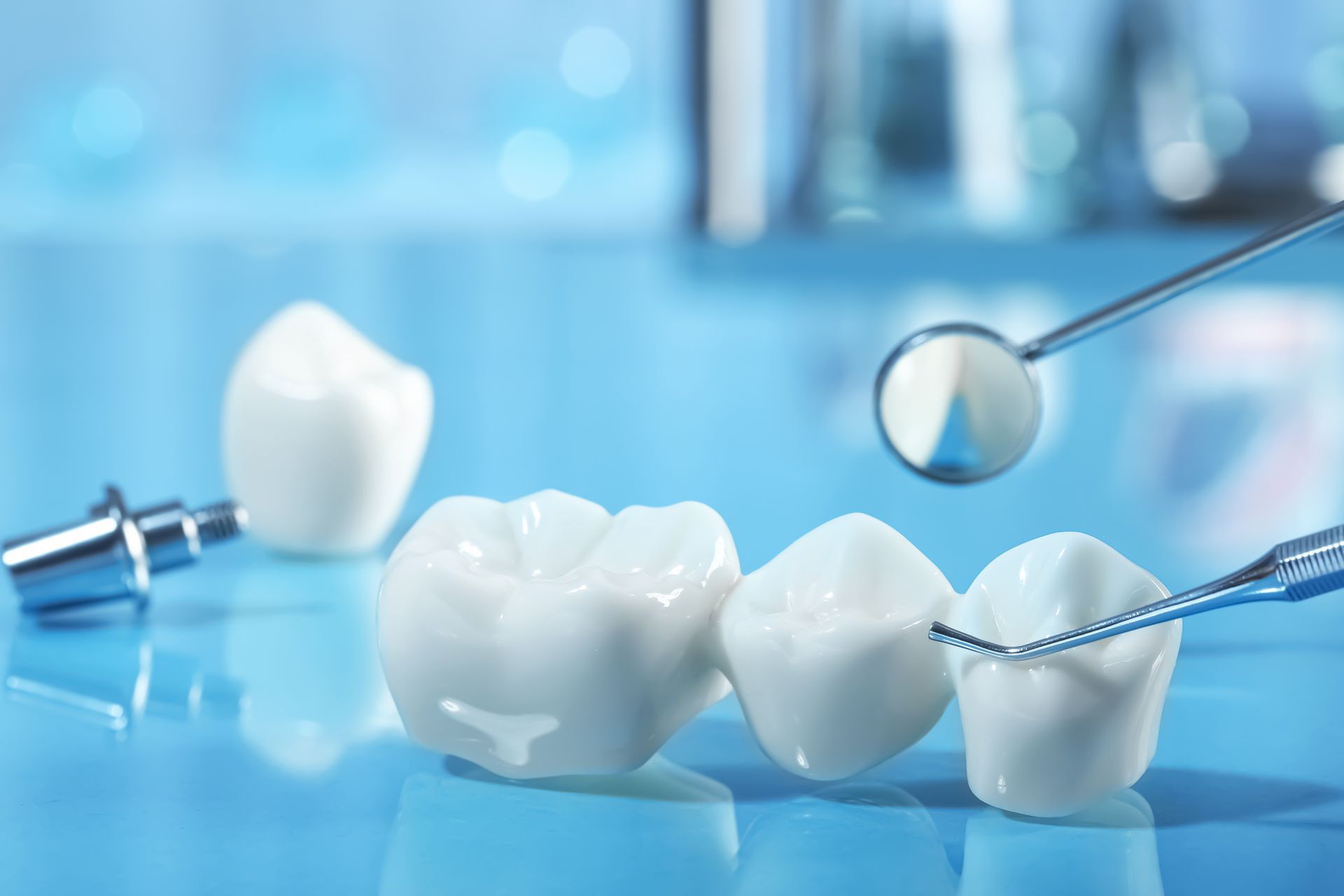 Close-up showcasing dental crowns with medical tools, representing dental precision and care.