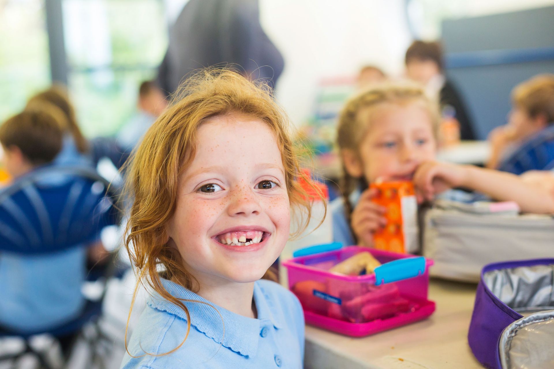 Smiling Girl Missing a Tooth with a Healthy Lunch — Kempsey, NSW — Kempsey Family Day Care
