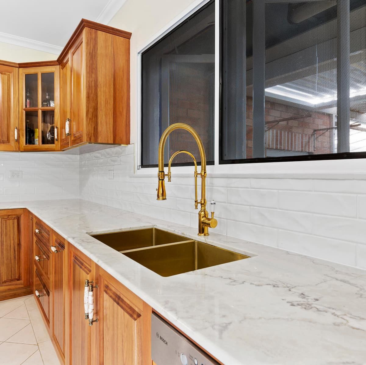 Gold Plated Sink and Wall Mounted Wooden Cabinets — Keppel Kitchens in Yeppoon, QLD