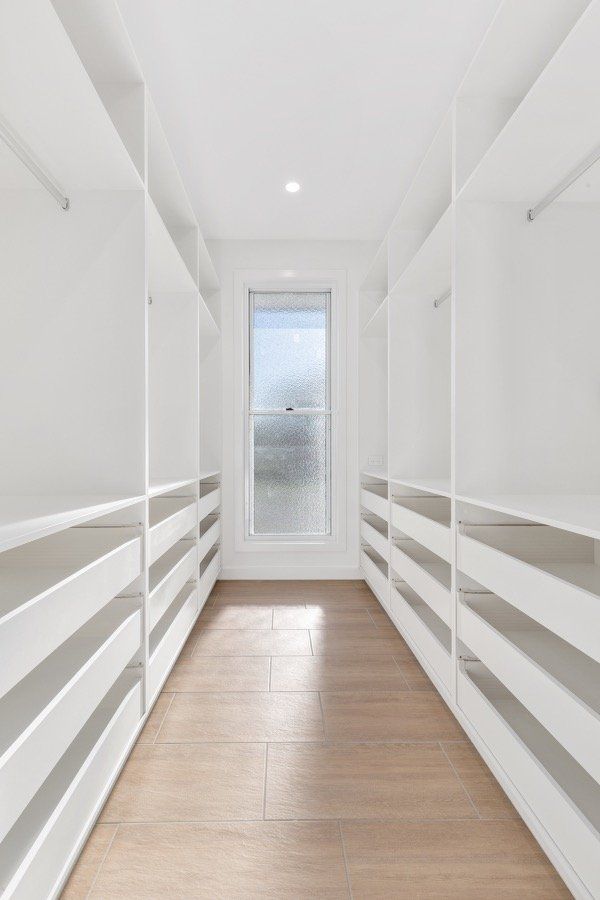 Walk-in Wardrobe with White Cabinet Doors — Keppel Kitchens in Yeppoon, QLD