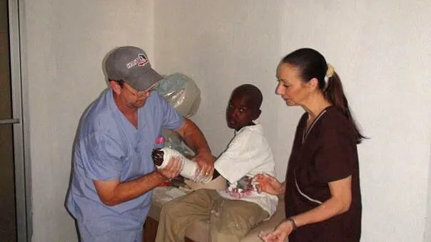 Man Assisting Child with Prosthetic Arm — Pembroke Pines, FL — Huse Artificial Limb & Brace