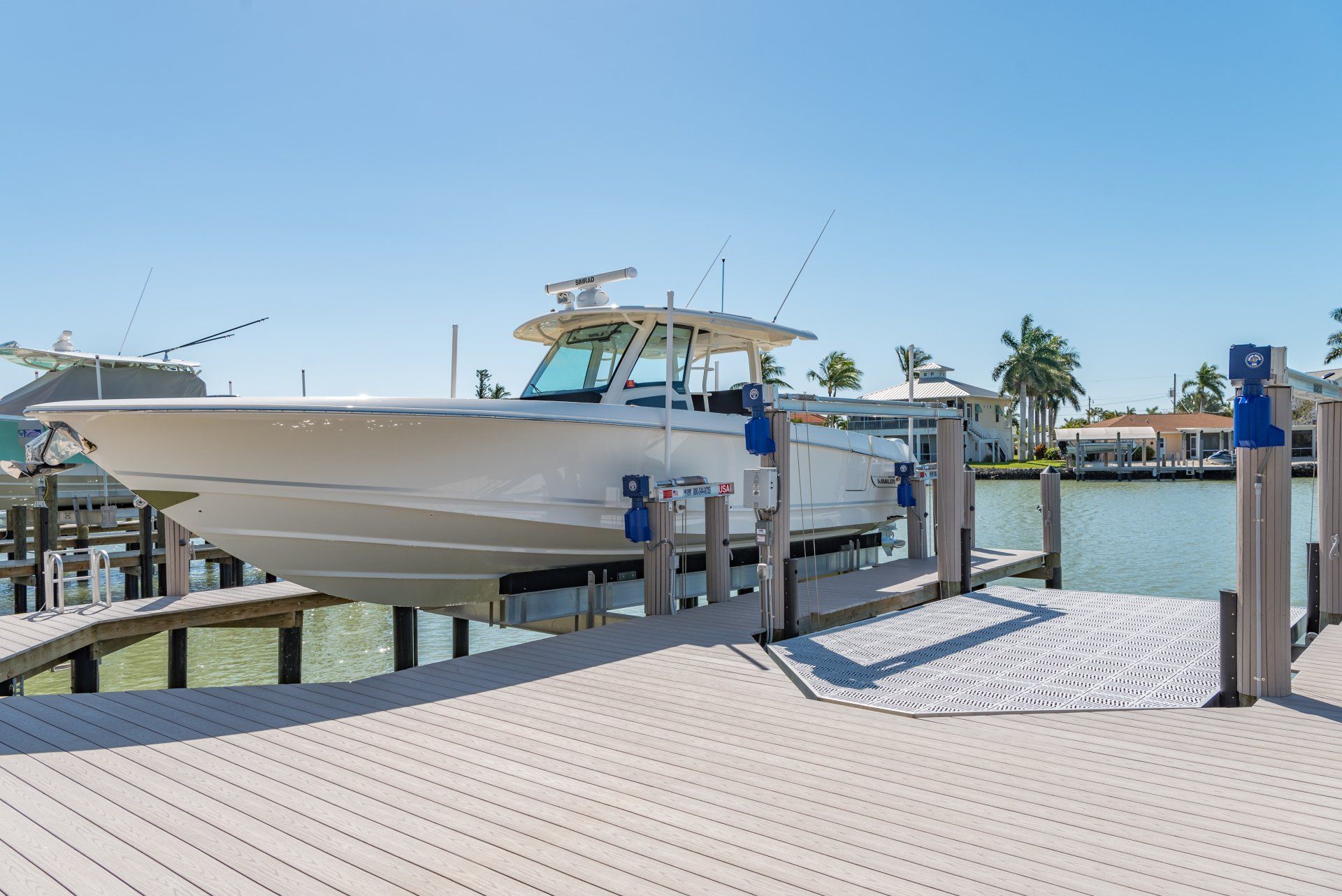 Side View of White Yacht — Marco Island, FL — Collier Seawall & Dock