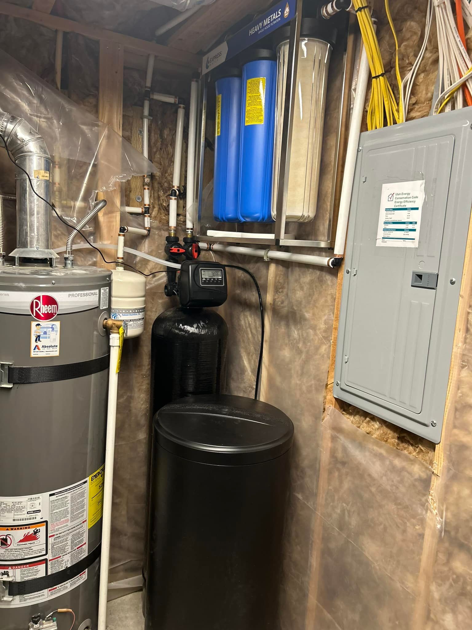Water heater and water filtration system in a basement setting.