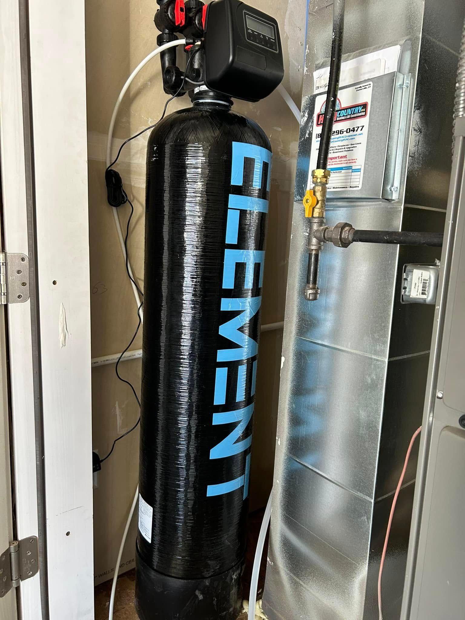 Black water softener labeled 