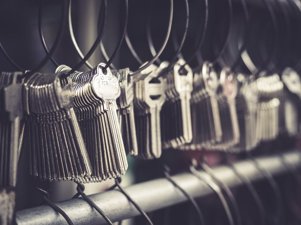 A Bunch of Keys Are Hanging on A Wire Rack — East Coast Locksmiths in Port Macquarie, NSW