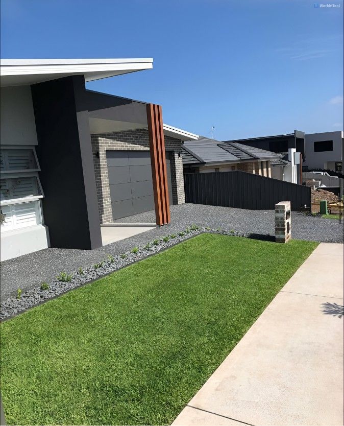 A House With a Lush Green Lawn in Front of It — Superior Turf in Oak Flats, NSW