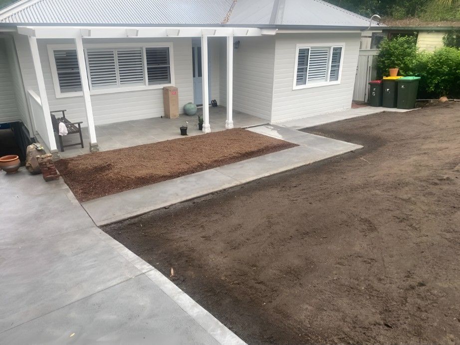 A House With a Porch and a Concrete Walkway in Front of It — Superior Turf in Badagarang, NSW