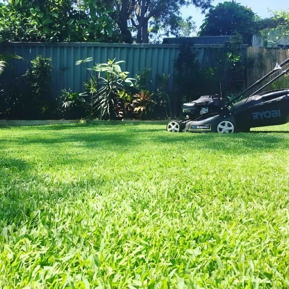 A Lawn Mower is Sitting on Top of a Lush Green Lawn — Superior Turf in Illawarra, NSW