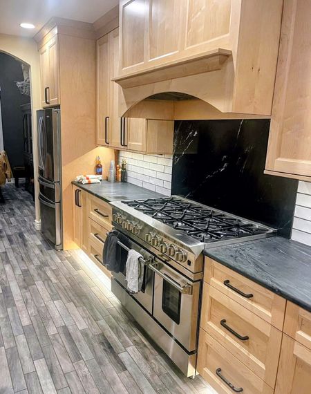 A kitchen with a table and chairs in it