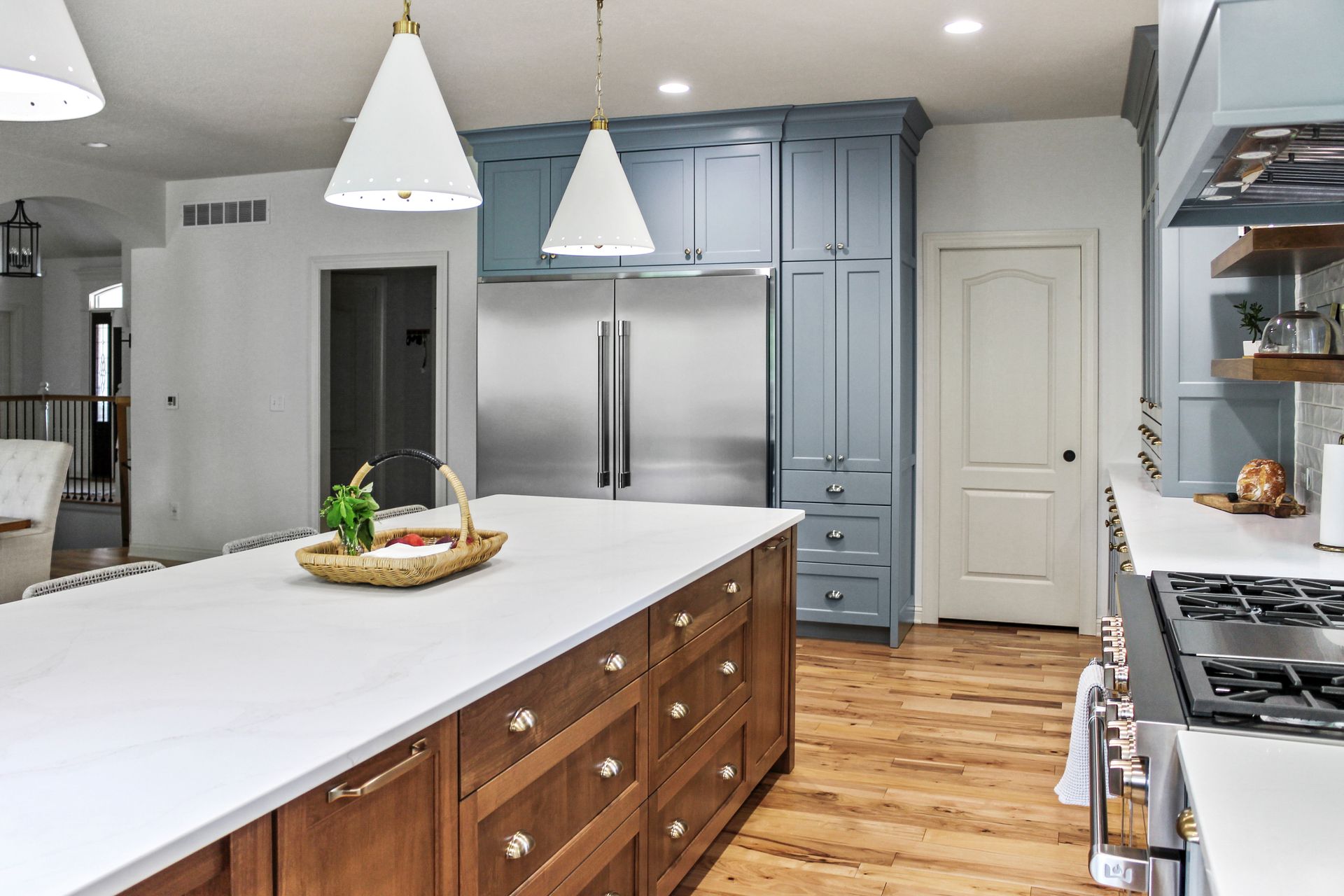 A kitchen with stainless steel appliances , wooden cabinets , and a large island.