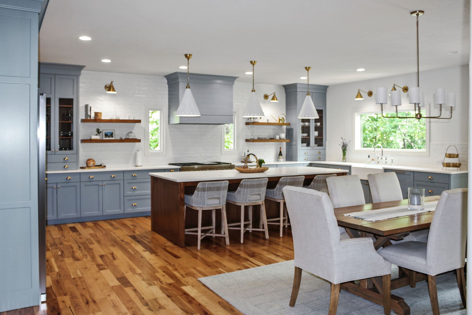 A kitchen and dining room in a house with a table and chairs.
