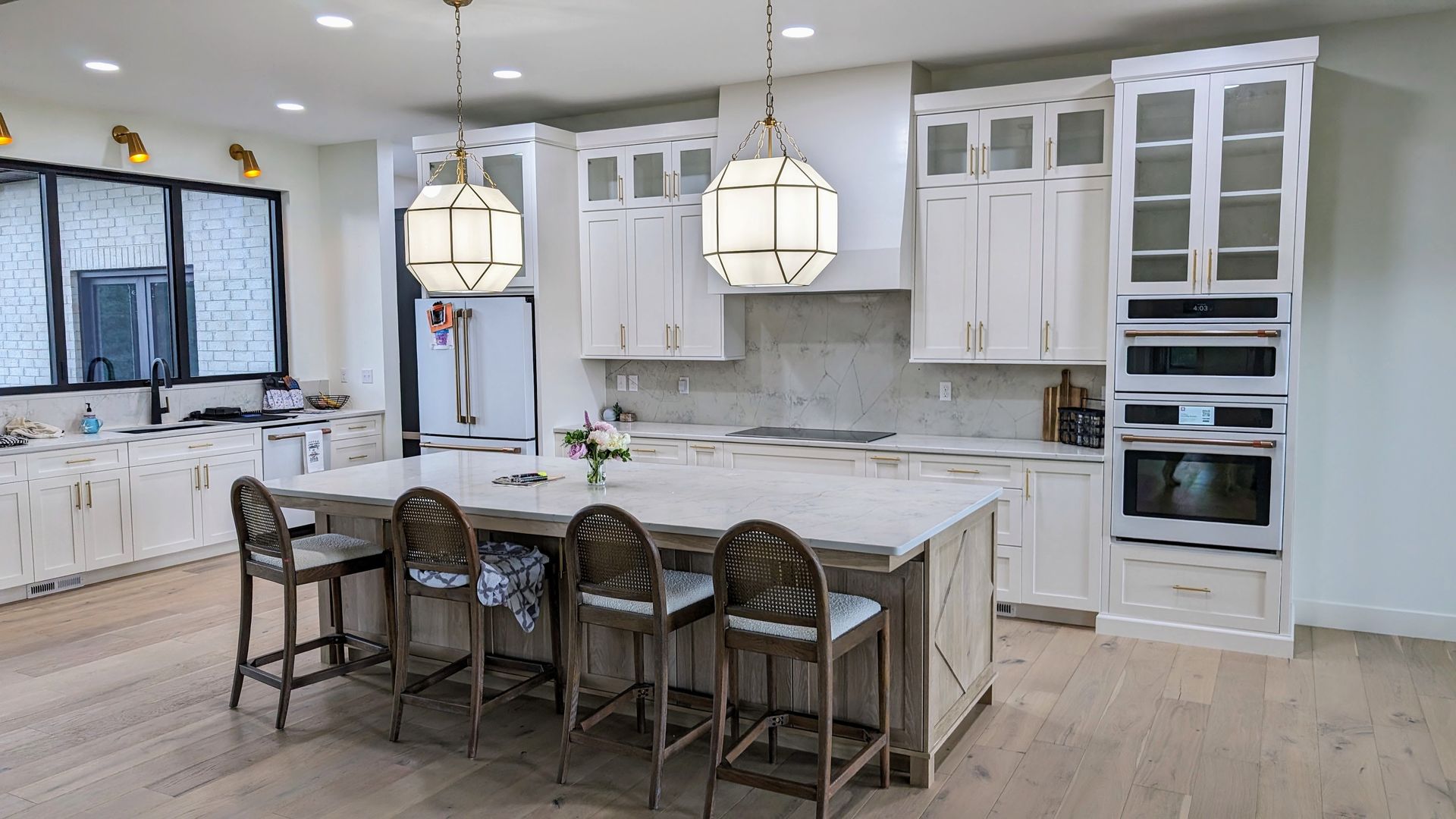 A large kitchen with white cabinets and a large island.