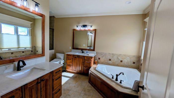 A bathroom with a toilet , sink , and shower.