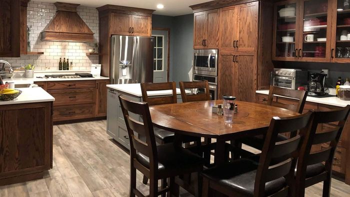 A kitchen with a table and chairs in it
