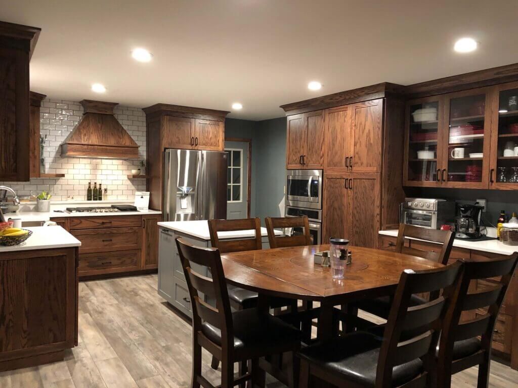A kitchen with a table and chairs in it.