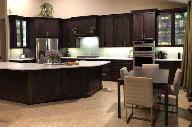 A kitchen with a table and chairs in it