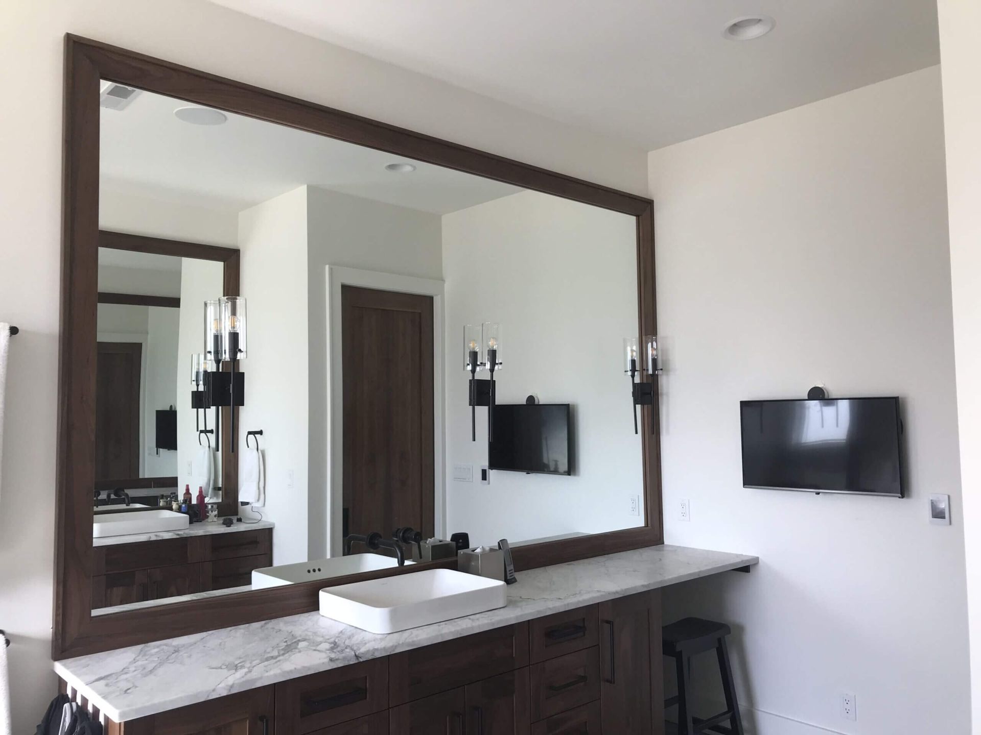 A bathroom with two sinks and a large mirror.