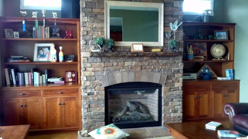 A living room with a fireplace and a mirror