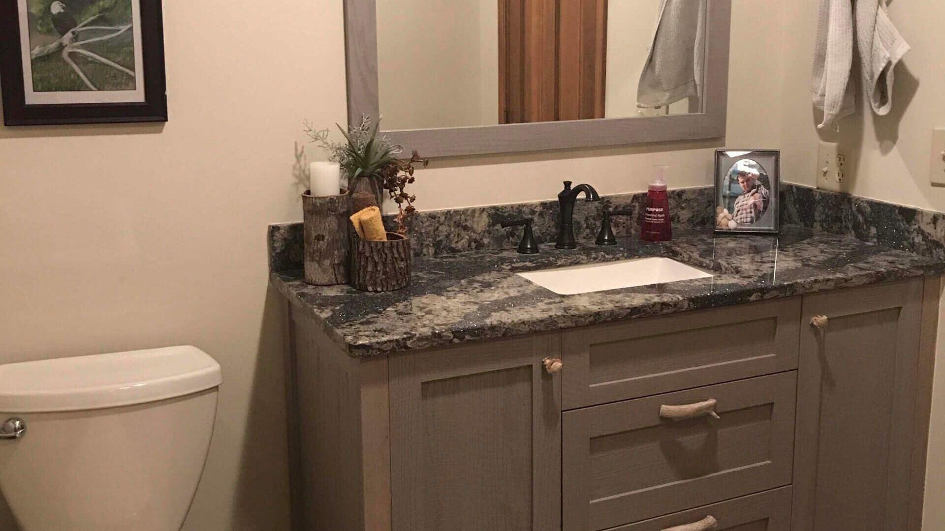 A bathroom with a toilet , sink , and shower.