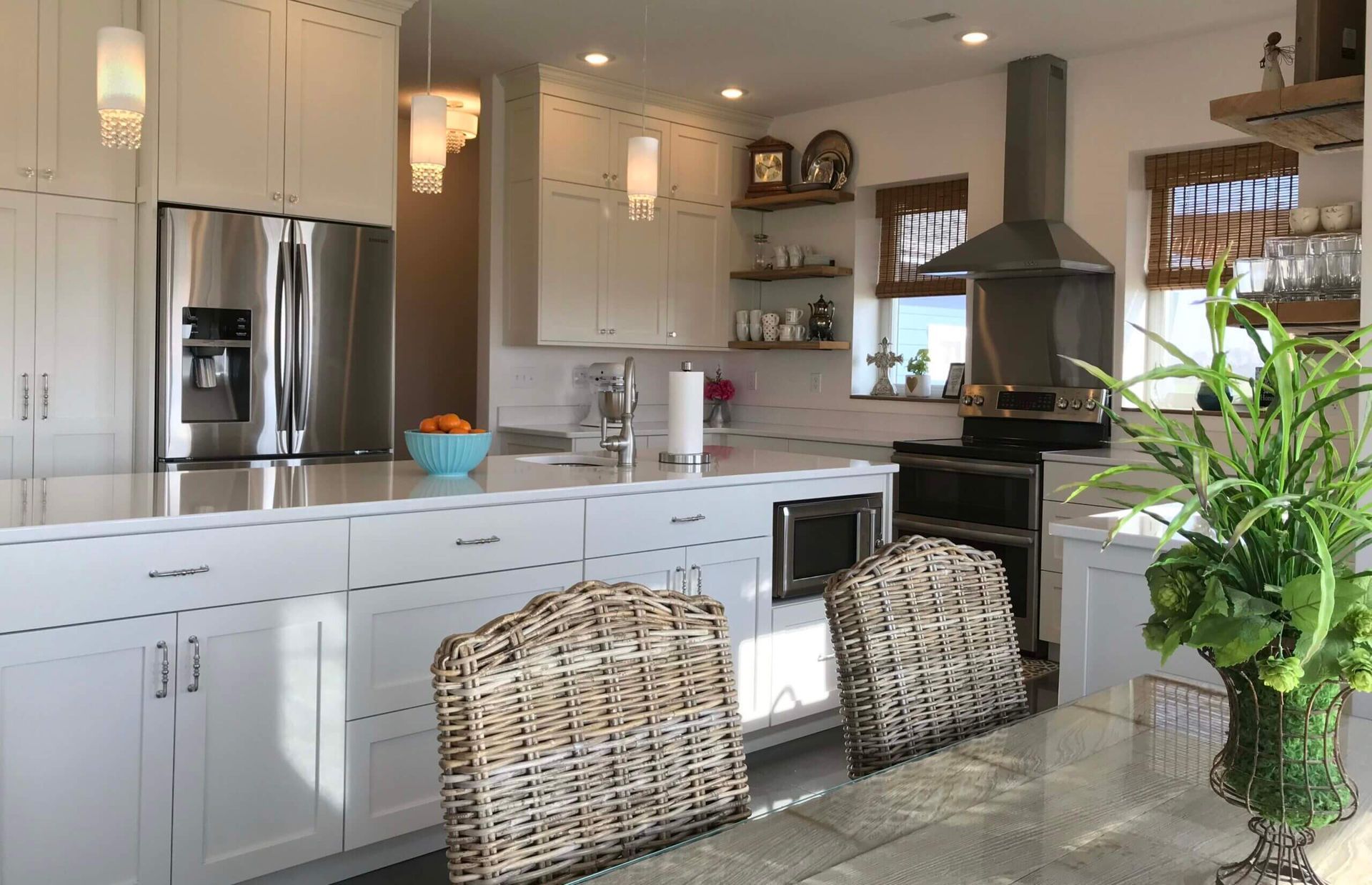 A kitchen with white cabinets and stainless steel appliances
