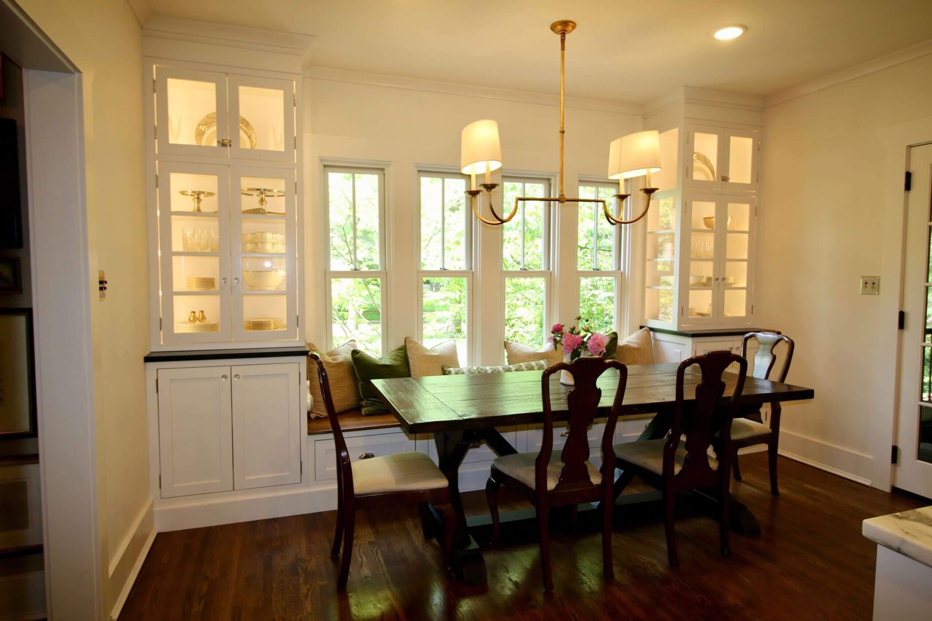 A dining room with a table and chairs and a chandelier
