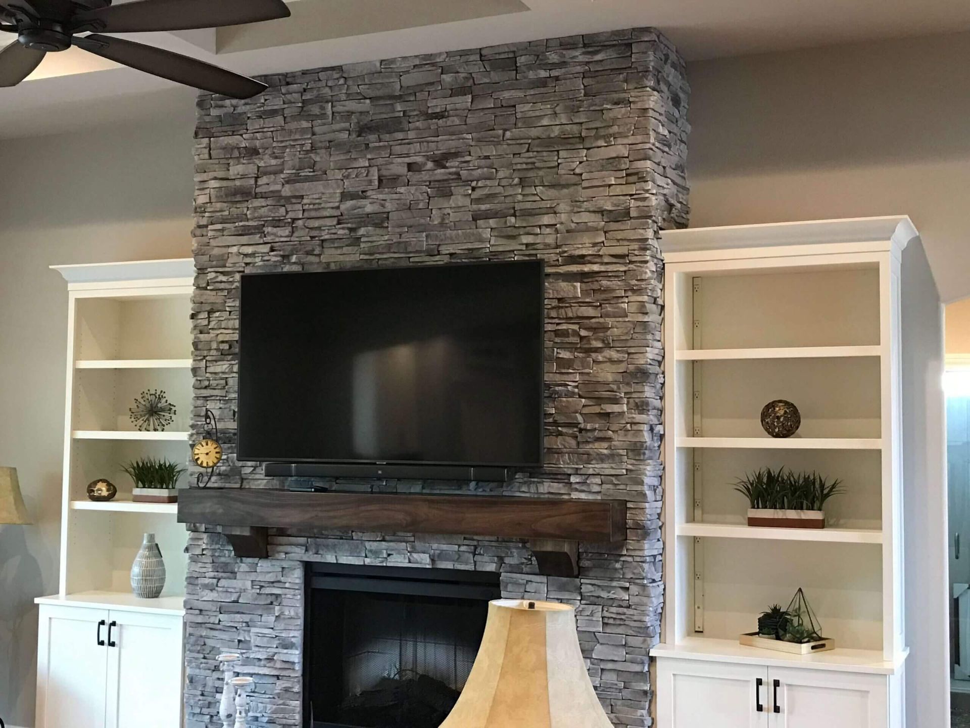A living room with a fireplace and a flat screen tv
