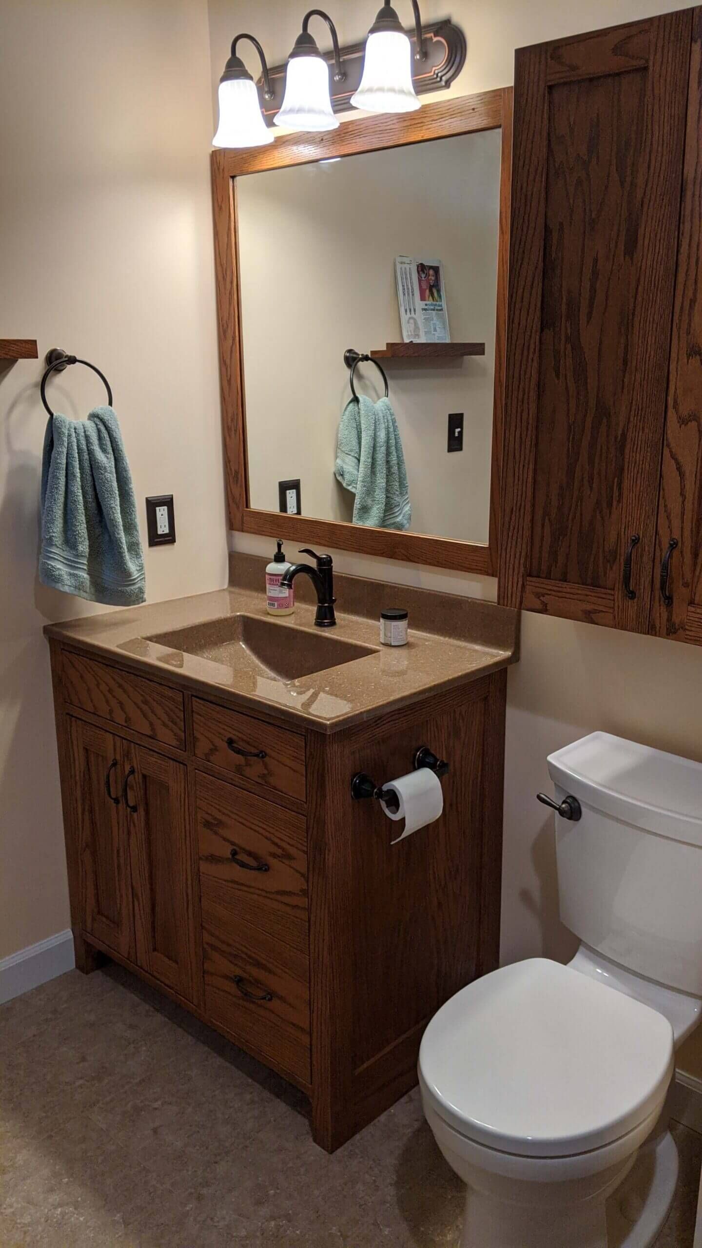 A bathroom with a sink , toilet and mirror.