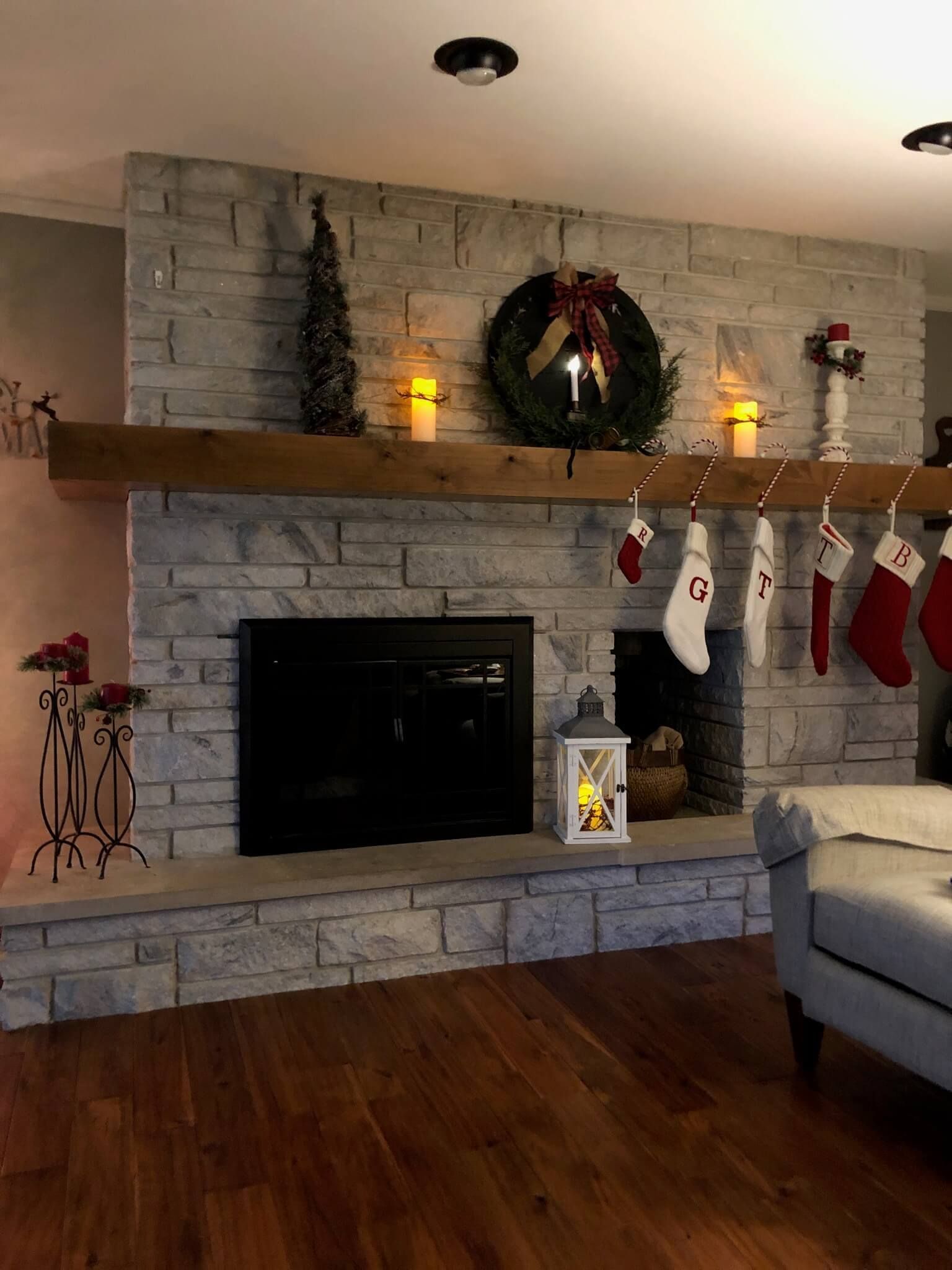 A living room with a fireplace and stockings on the mantle
