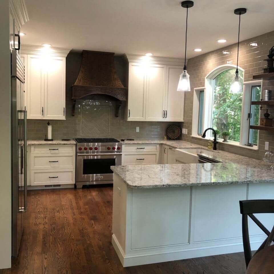 A bathroom with a toilet , sink , mirror and vanity.