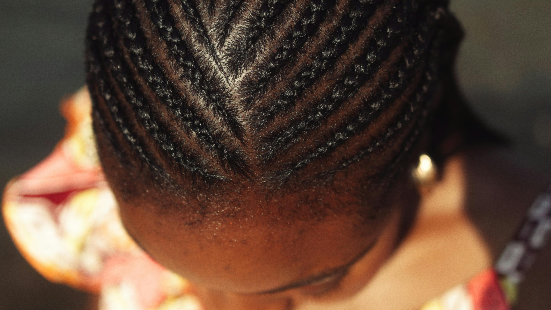 Close-up of neatly braided hair forming a V-shape pattern on a dark scalp.