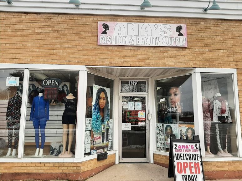 Exterior of a brick beauty supply store with mannequins in windows, sign 