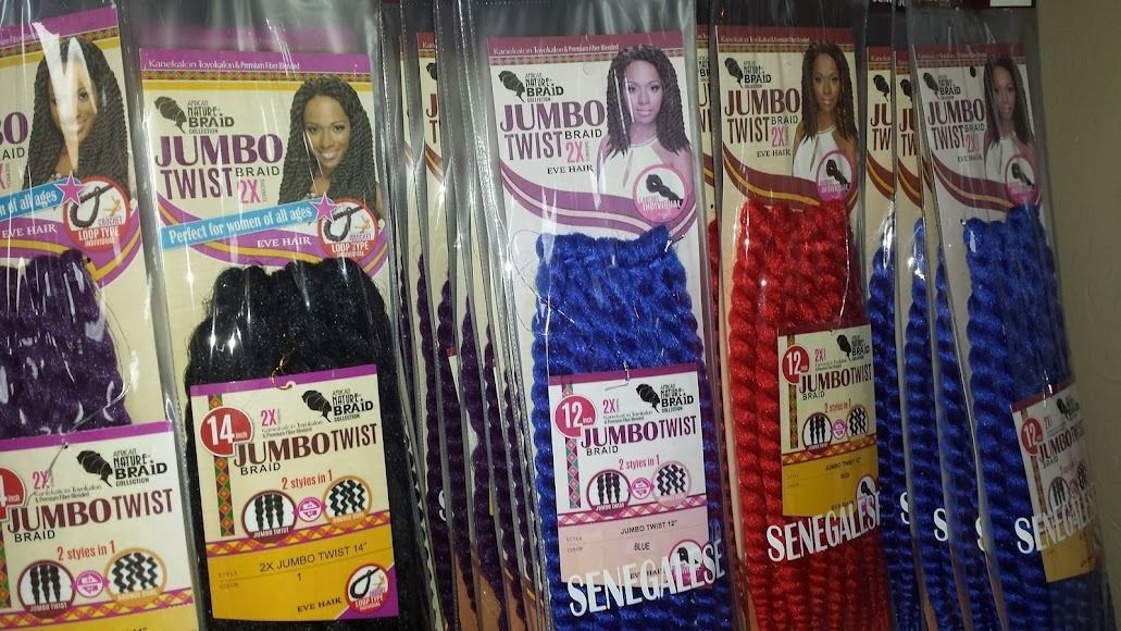 Bags of jumbo twist braiding hair in various colors, including purple, black, blue, and red, are displayed.