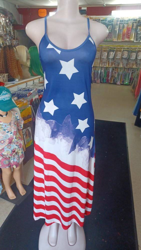 Mannequin wearing a red, white, and blue American flag-themed sundress inside a store.