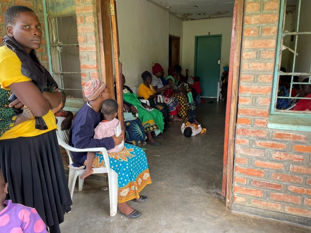 women and children lining up to be seen at the Sparkle outreach clinic in Namitembo, Malawi. 