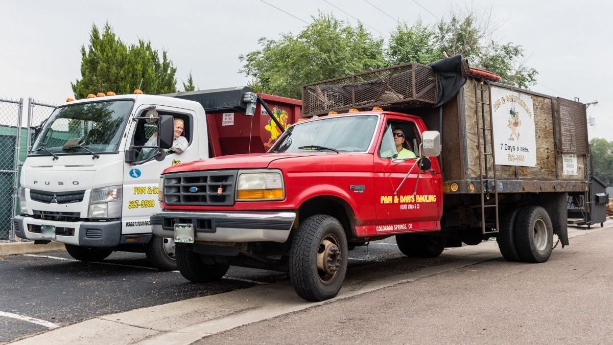 A red dumpster from pam and dan 's hauling