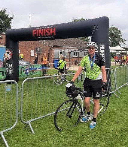 Photograph of Team Rider David after completing Norfolk Sportive 2021 on his kick scooter.