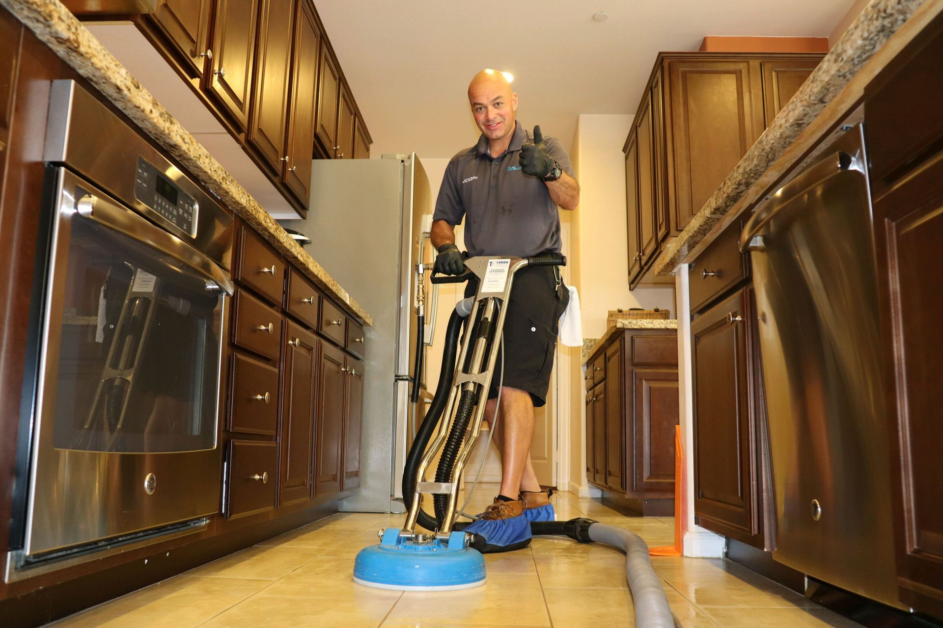 Petrichor technician happily cleaning tile and grout